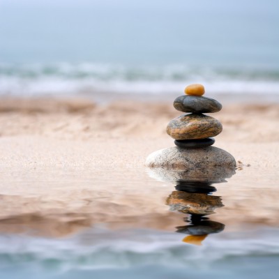 EMDR. wide shot pile of rocks on beach